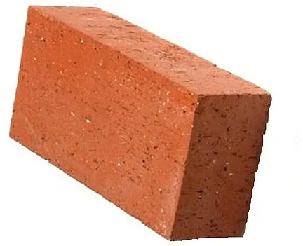 Single red clay brick on a white background